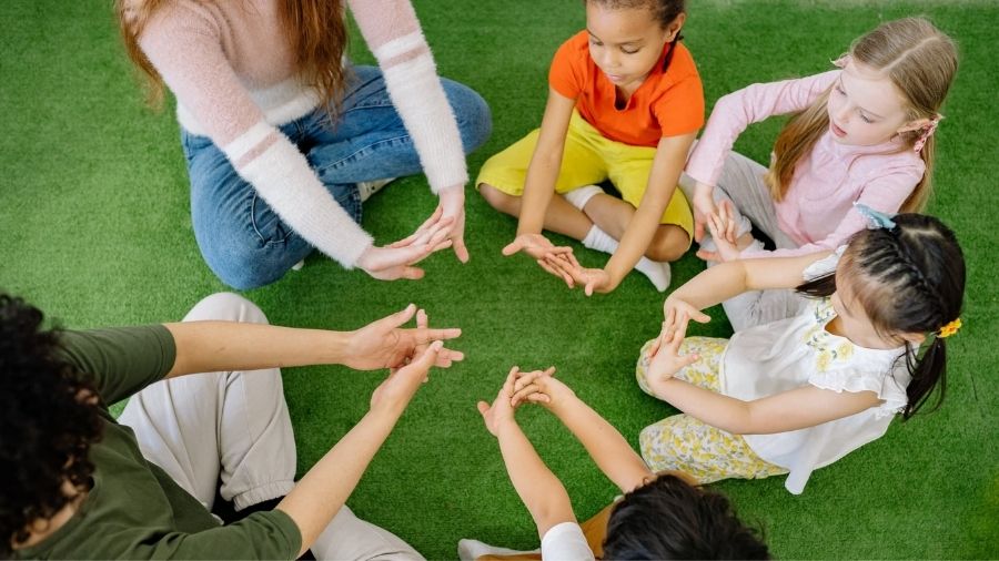 Kids stretching hands in a circle