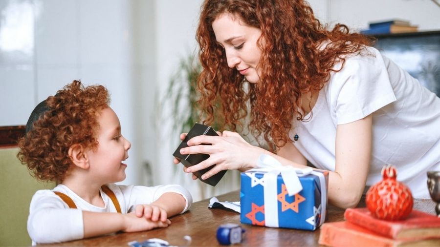 Woman opening present for a boy