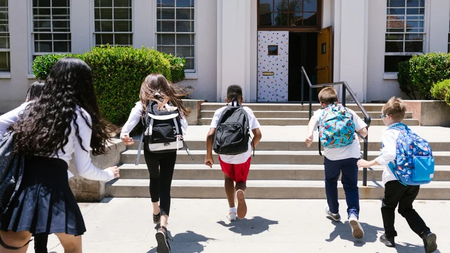 Five kids running into school